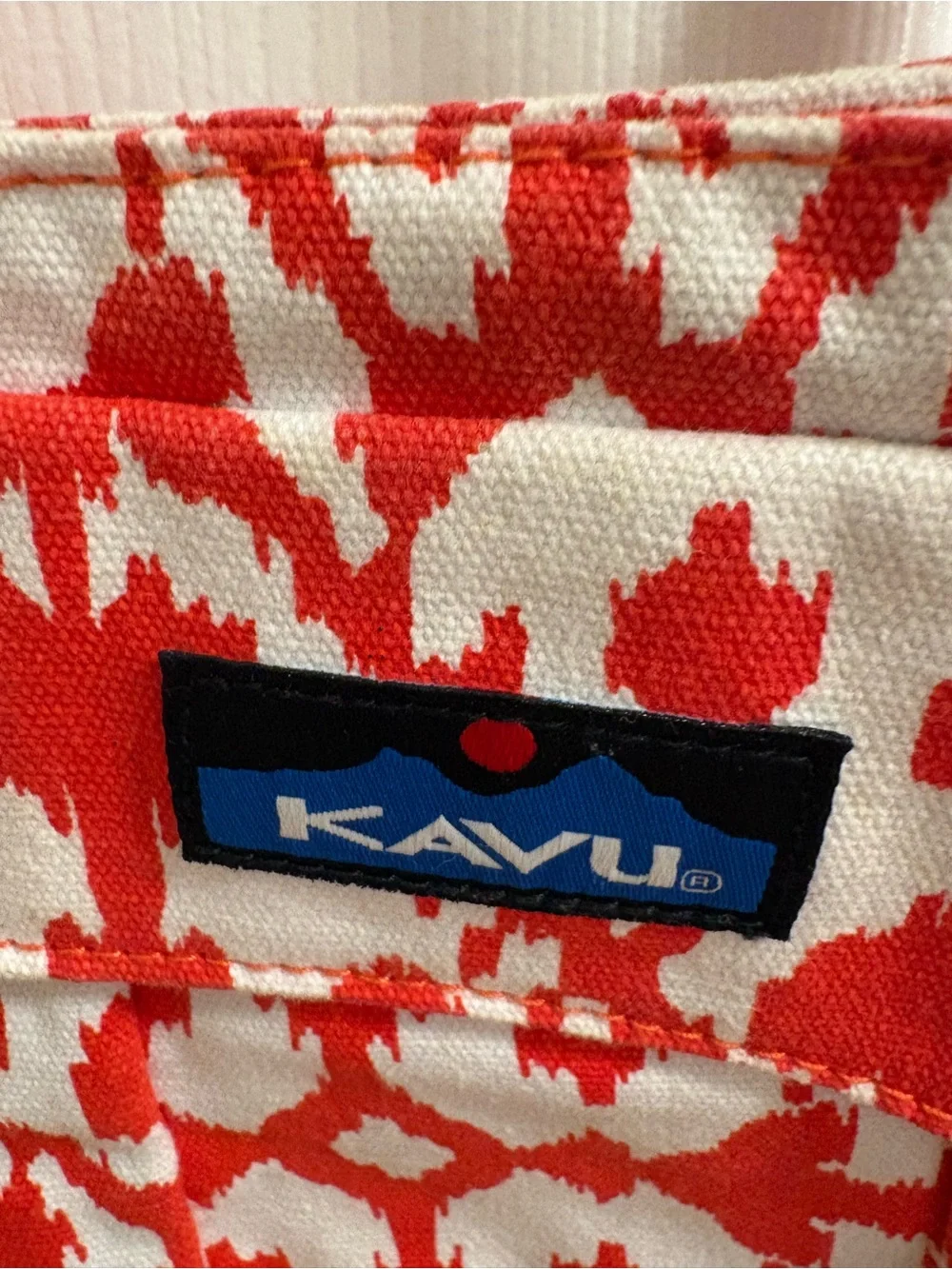 KAVU small cross body bag, orange and white pattern, snap top closure
